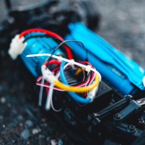 Macro shot of vibrant colored wires and components of an RC car model, showcasing detailed electronics.